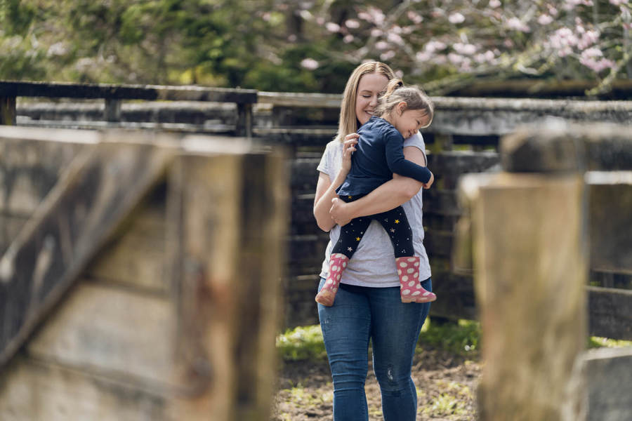 young mum holding smiling daughter Making a complaint.