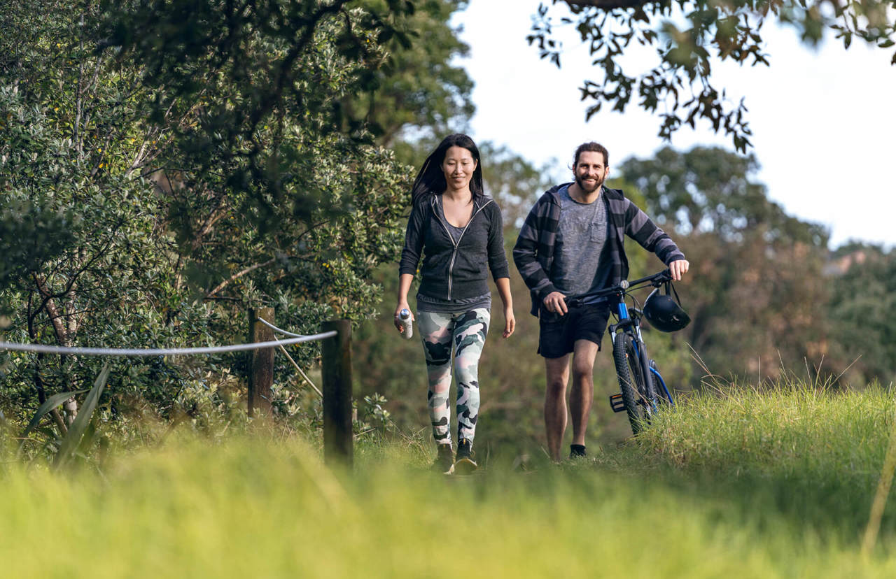 young couple with bike in the park