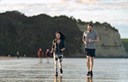 young couple running at the beach