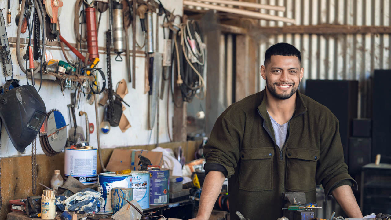 smiling young man at the workshop smiling young man at the workshop