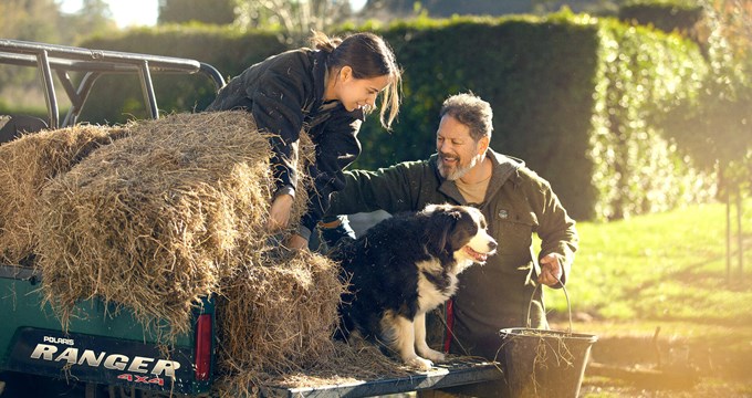 farmer and daughter by ute with hay farm dog