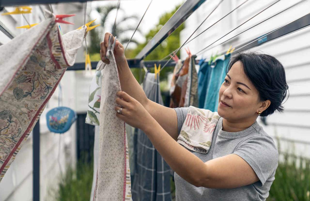 Lady hanging washed clothes