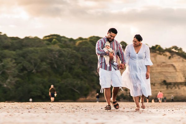 Couple holding a new born on a walk