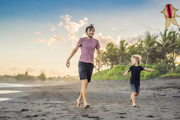 Dad and son flying a kite