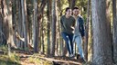 young couple laughing in the forest