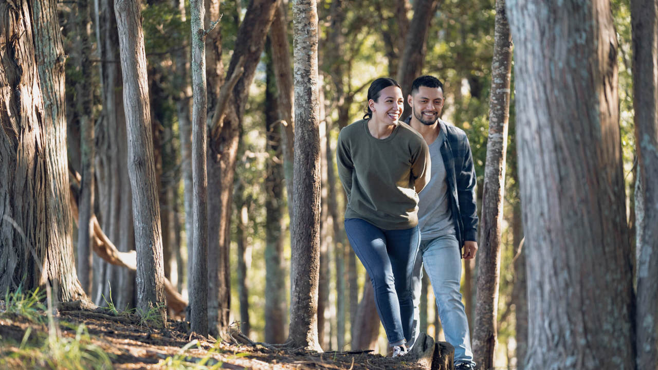 young couple laughing in the forest