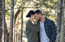 young couple holding each other in the forest