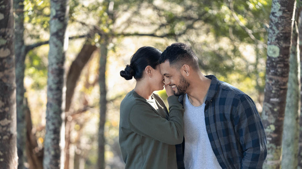 young couple holding each other in the forest young couple holding each other in the forest