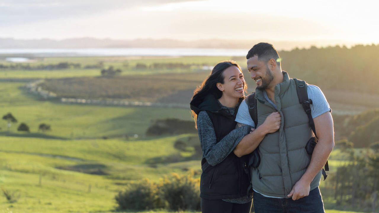 young couple smiling in the park
